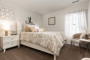 Bedroom with Plush Carpeting and Large Window