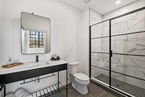 a bathroom with a shower toilet and sink and a mirror