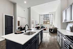 a kitchen with a large white counter top and a sink
