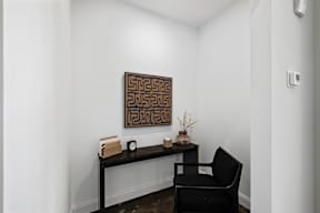 room with a desk and a chair and a painting on the wall