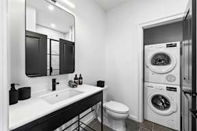 a bathroom with a toilet sink and a washing machine