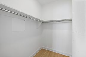 the living room of an empty apartment with white walls and a wood floor