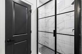 a black and white photo of a glass door with a reflection of a window