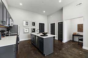 a kitchen with a center island and a counter top in a new home
