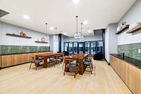a dining room with wooden tables and chairs and a large window