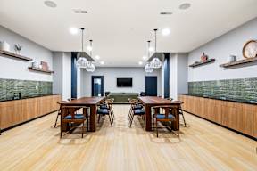 a dining room with wooden tables and chairs and a green couch