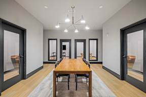 a dining room with a wooden table and chairs and a chandelier