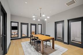 a dining room with a wooden table and chairs