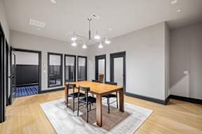 a dining room with a wooden table and chairs