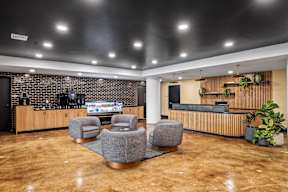 a lobby with chairs and a reception desk