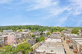 an aerial view of a city street with buildings and trees