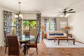 A living room with a glass table and chairs.