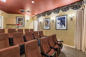 A row of red seats in a movie theater.