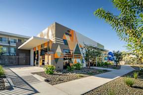A modern building with a colorful facade and the number 5900 on it.