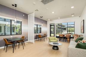 A modern dining room with a glass table and chairs.