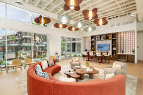 A modern living room with a red sofa and a coffee table.