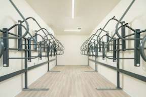 A gym with a row of parallel bars.