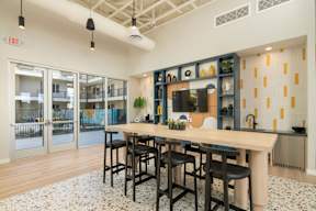 A kitchen with a bar area and a dining table.