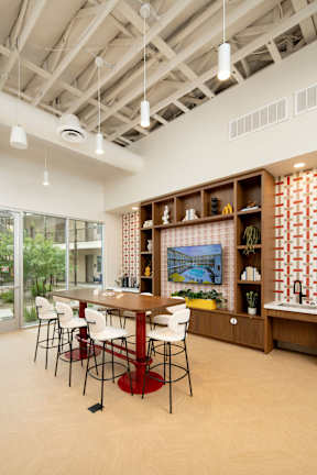 A dining room with a wooden table and chairs.