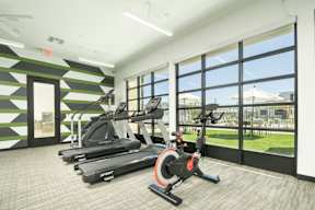 A gym with treadmills and exercise bikes.
