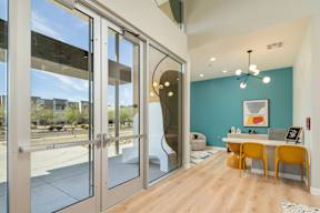 A room with a blue wall and a table with chairs.