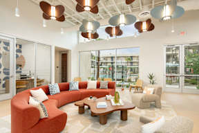 A modern living room with a red couch and a coffee table.