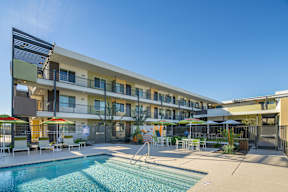 A large apartment complex with a pool and patio area.