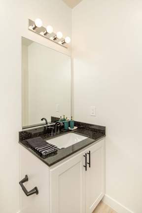 A bathroom with a sink and a mirror.