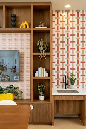A kitchen with a wooden shelf and a sink.