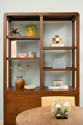 A wooden shelf with various items on it.