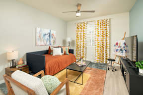 A bedroom with a bed, chair, and painting on the wall.