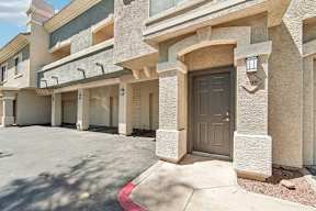 A building with a brown door and a number 219 on the wall.