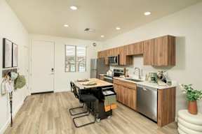 A kitchen with a wooden counter and stainless steel appliances.