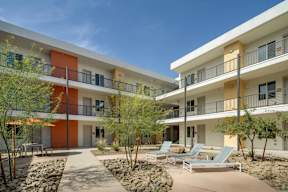 A modern building with orange and white balconies.