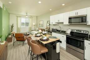 A kitchen with a table set for a meal.