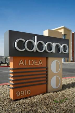 A sign for a place called "Caboama ALDEA" with the number 9910 on it.