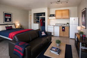 A living room with a couch and a bear down sign on the wall.