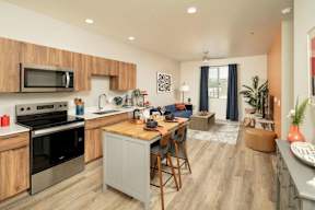 A modern kitchen with wooden cabinets and a grey island.