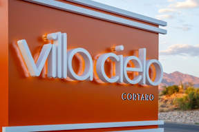 A sign with the word "VillaCielo" in white letters on an orange background.