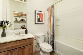 A white toilet sits next to a sink in a bathroom.