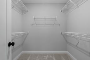 the spacious walk-in closet in the master bedroom of a manufactured home with two hanging closets