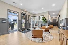 A spacious lobby with wooden floors and a variety of seating options.