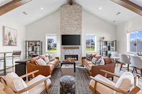 A living room with a fireplace and leather couches.