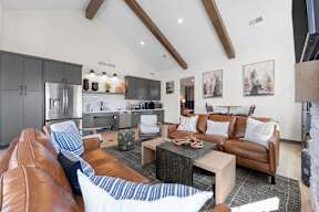 A modern living room with brown leather couches and a wooden coffee table.