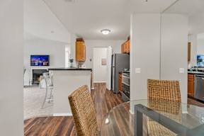 A modern kitchen with a bar area and a dining table set up.