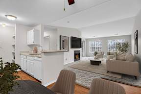 A modern living room with a fireplace and a dining table.