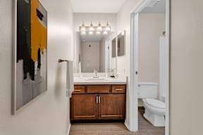 A bathroom with a white toilet and a white sink.