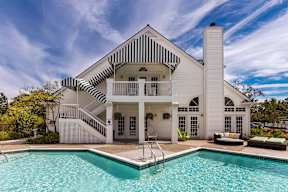 a white house with a pool and a