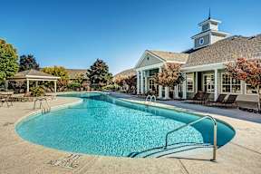 A pool with a building in the background.