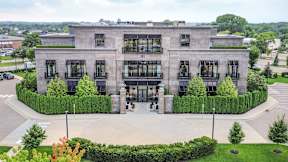 an aerial view of a building with a courtyard and trees